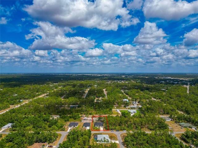 aerial overview of property's location with property boundaries highlighted and a heavily wooded area