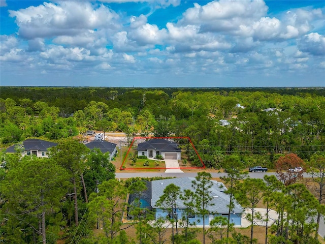 aerial view of property's location featuring a heavily wooded area and property parcel outlined