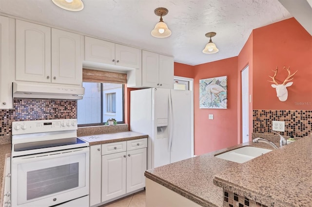 kitchen with white appliances, under cabinet range hood, a sink, decorative backsplash, and white cabinets