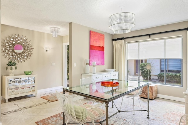 dining area with light tile patterned floors, a chandelier, baseboards, and a textured ceiling