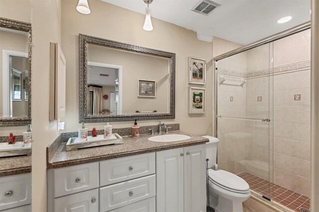 full bath with a shower stall, toilet, and vanity