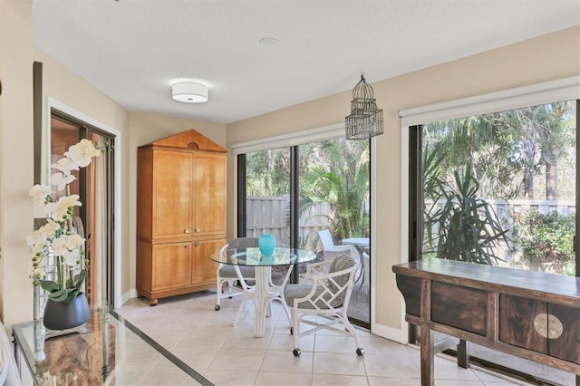 dining room featuring baseboards and light tile patterned flooring