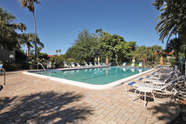 community pool featuring fence and a patio area