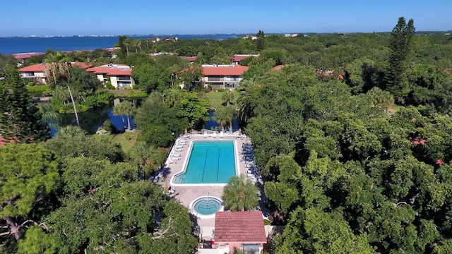 view of property location with a pool and a nearby body of water