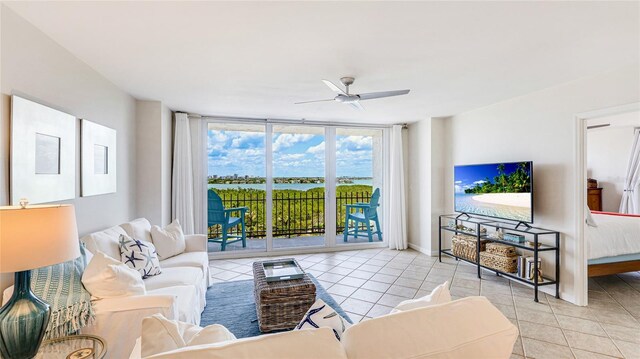 1212 Benjamin Franklin Dr Unit 909, Sarasota, FL 34236 - tiled living room with ceiling fan, expansive windows, and baseboards