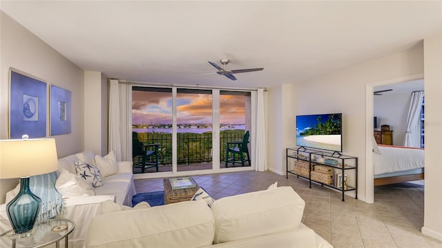1212 Benjamin Franklin Dr Unit 909, Sarasota, FL 34236 - tiled living room with ceiling fan, floor to ceiling windows, and baseboards