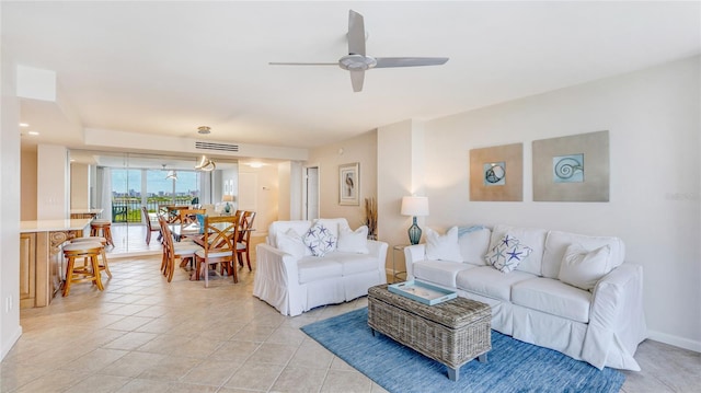 1212 Benjamin Franklin Dr Unit 909, Sarasota, FL 34236 - living room with a ceiling fan, light tile patterned flooring, and baseboards