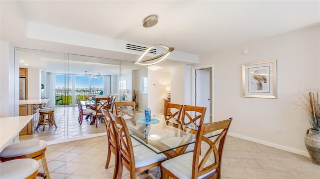 1212 Benjamin Franklin Dr Unit 909, Sarasota, FL 34236 - dining area featuring light tile patterned floors and baseboards