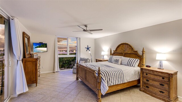 1212 Benjamin Franklin Dr Unit 909, Sarasota, FL 34236 - bedroom with access to outside, ceiling fan, light tile patterned floors, and baseboards