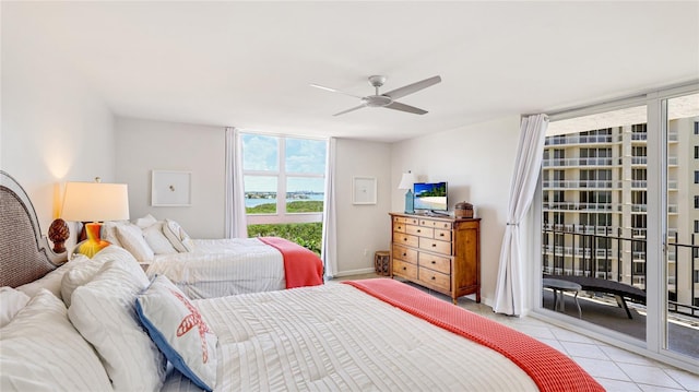 1212 Benjamin Franklin Dr Unit 909, Sarasota, FL 34236 - bedroom with access to exterior, light tile patterned flooring, and ceiling fan