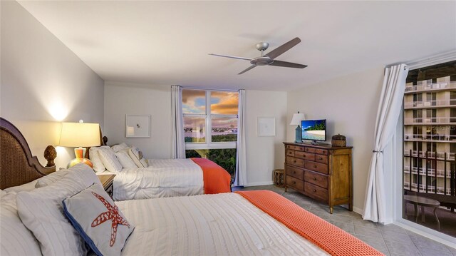 1212 Benjamin Franklin Dr Unit 909, Sarasota, FL 34236 - bedroom featuring tile patterned flooring, a ceiling fan, and access to exterior
