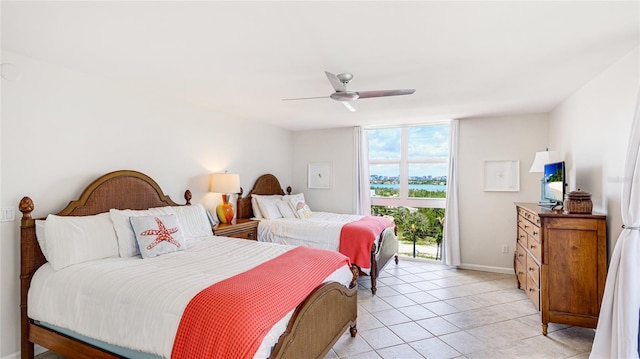 1212 Benjamin Franklin Dr Unit 909, Sarasota, FL 34236 - bedroom featuring light tile patterned floors, ceiling fan, and baseboards