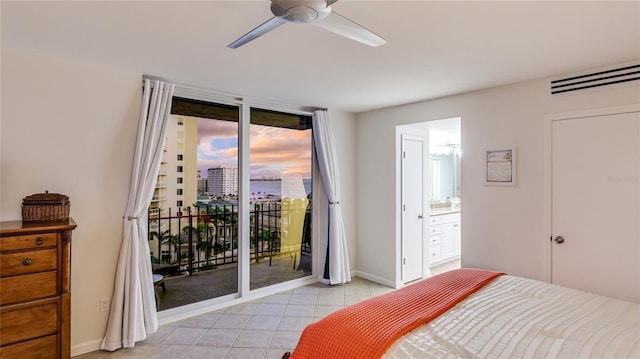 1212 Benjamin Franklin Dr Unit 909, Sarasota, FL 34236 - bedroom featuring access to outside, light tile patterned flooring, connected bathroom, ceiling fan, and baseboards