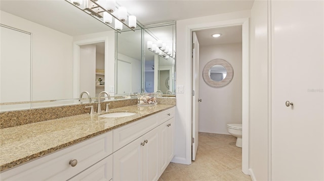 1212 Benjamin Franklin Dr Unit 909, Sarasota, FL 34236 - bathroom featuring toilet, vanity, and tile patterned floors