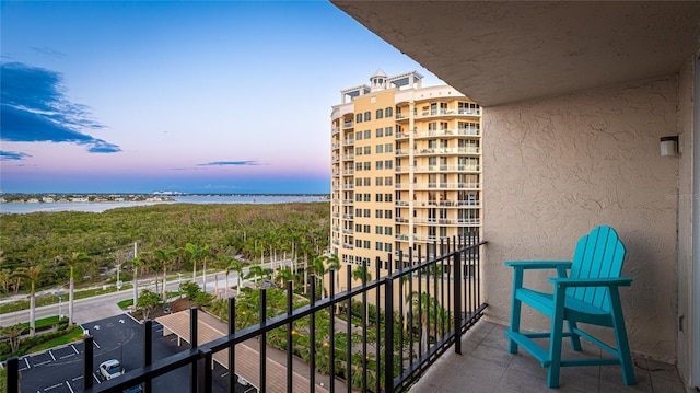 1212 Benjamin Franklin Dr Unit 909, Sarasota, FL 34236 - balcony at dusk featuring a water view