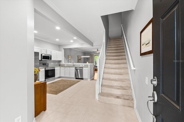 foyer with crown molding, light tile patterned flooring, baseboards, stairs, and recessed lighting