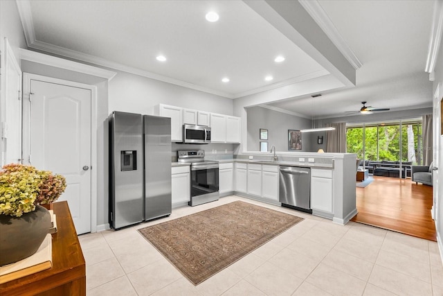 kitchen featuring stainless steel appliances, a peninsula, open floor plan, ceiling fan, and light tile patterned flooring