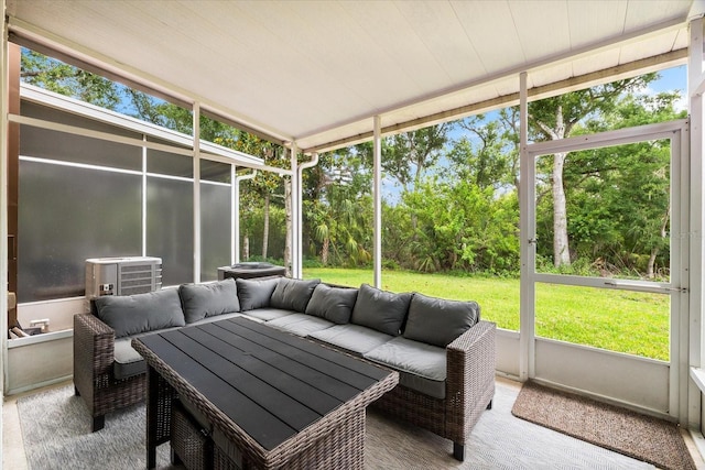 sunroom with an outdoor living space and healthy amount of natural light
