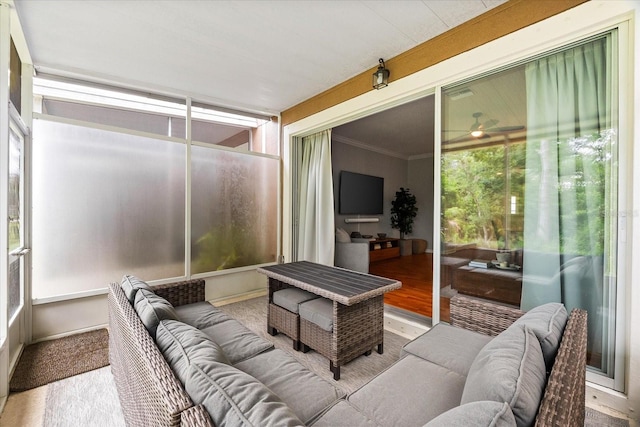 sunroom with an outdoor living space and a ceiling fan