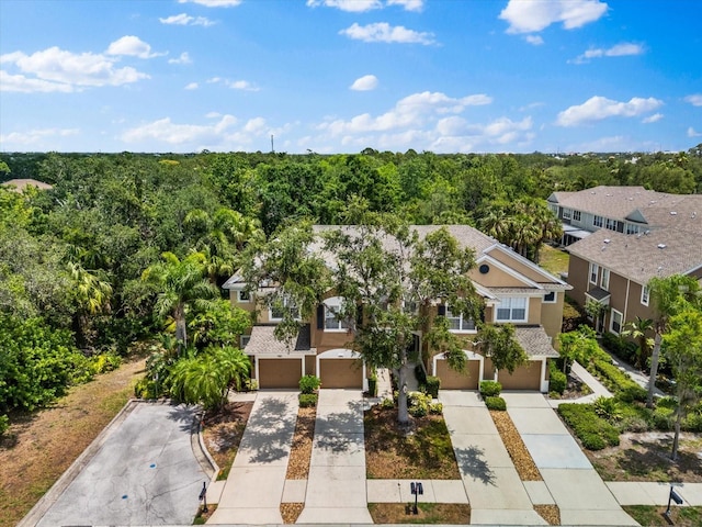 aerial perspective of suburban area featuring a heavily wooded area