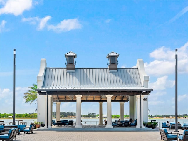 view of property's community with a gazebo and a water view