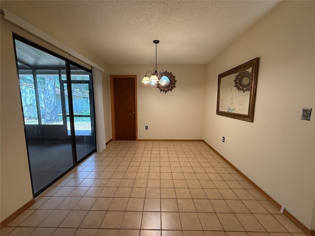 3957 Bearded Oaks Ct, Sarasota, FL 34232 - empty room with a chandelier, a textured ceiling, and baseboards