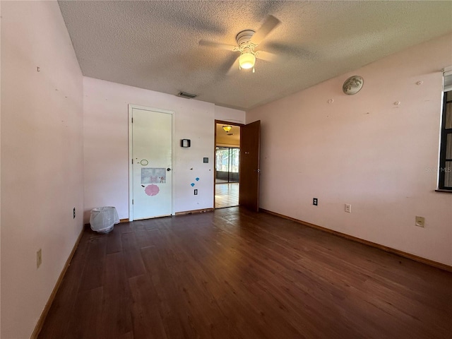 3957 Bearded Oaks Ct, Sarasota, FL 34232 - spare room with a textured ceiling, dark wood-type flooring, a ceiling fan, and baseboards