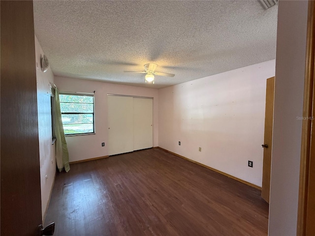 3957 Bearded Oaks Ct, Sarasota, FL 34232 - unfurnished bedroom with wood finished floors, a textured ceiling, a closet, baseboards, and ceiling fan