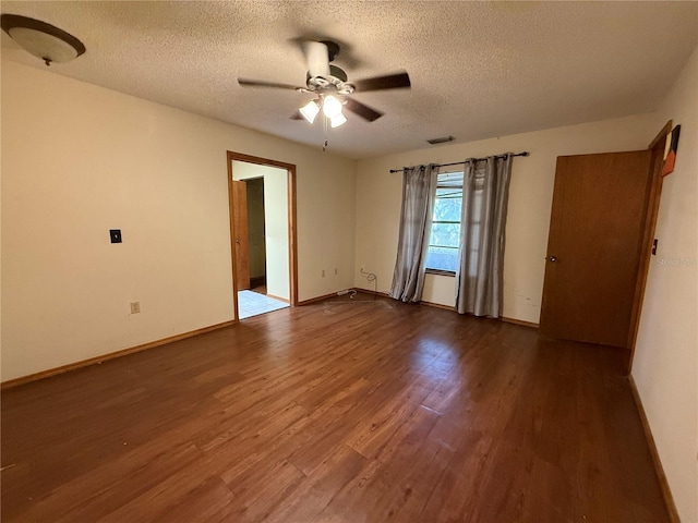 3957 Bearded Oaks Ct, Sarasota, FL 34232 - spare room with a textured ceiling, wood finished floors, ceiling fan, and baseboards