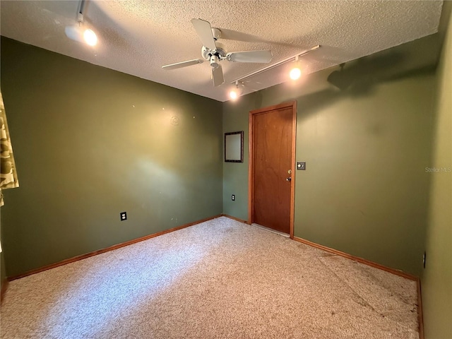 3957 Bearded Oaks Ct, Sarasota, FL 34232 - carpeted empty room featuring track lighting, a textured ceiling, a ceiling fan, and baseboards