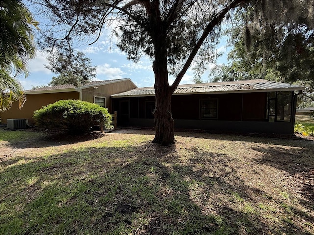 3957 Bearded Oaks Ct, Sarasota, FL 34232 - rear view of property with a sunroom, central AC unit, and metal roof