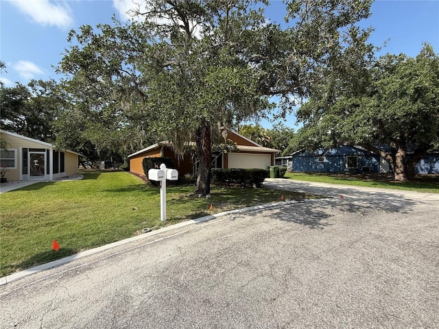 3957 Bearded Oaks Ct, Sarasota, FL 34232 - view of front of property with concrete driveway, a front yard, and an attached garage