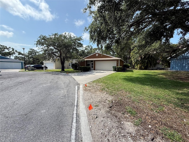 3957 Bearded Oaks Ct, Sarasota, FL 34232 - view of front facade featuring concrete driveway, a front lawn, and an attached garage