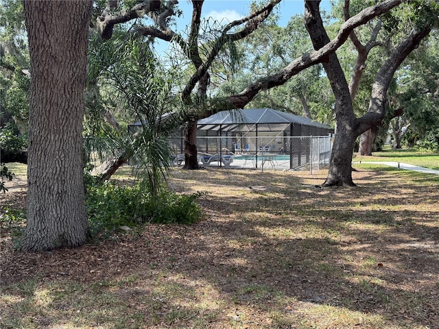3957 Bearded Oaks Ct, Sarasota, FL 34232 - view of yard with an outdoor pool and glass enclosure
