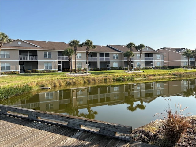dock area featuring a water view and a residential view