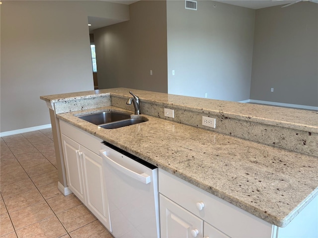 kitchen featuring light tile patterned floors, white dishwasher, visible vents, and a sink