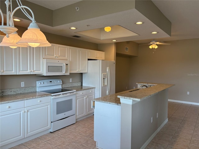 kitchen featuring light tile patterned floors, white appliances, and white cabinets