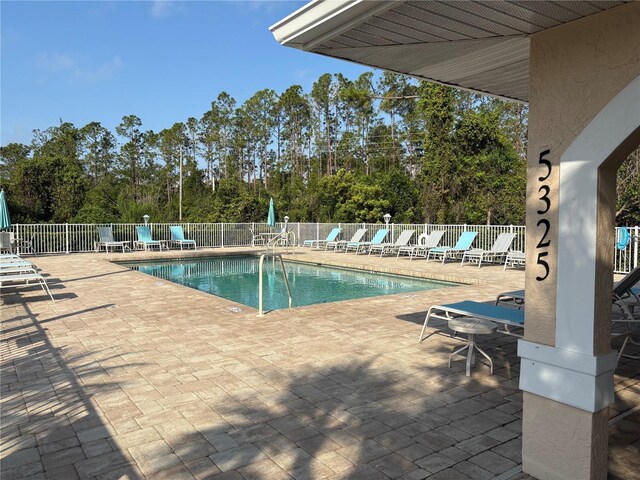 community pool featuring a patio and fence