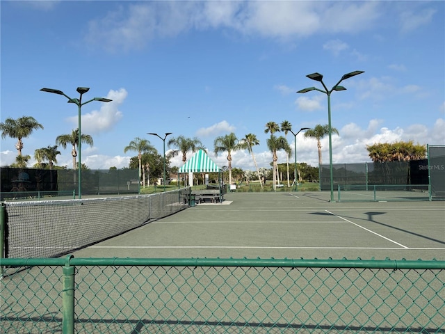 view of sport court featuring fence
