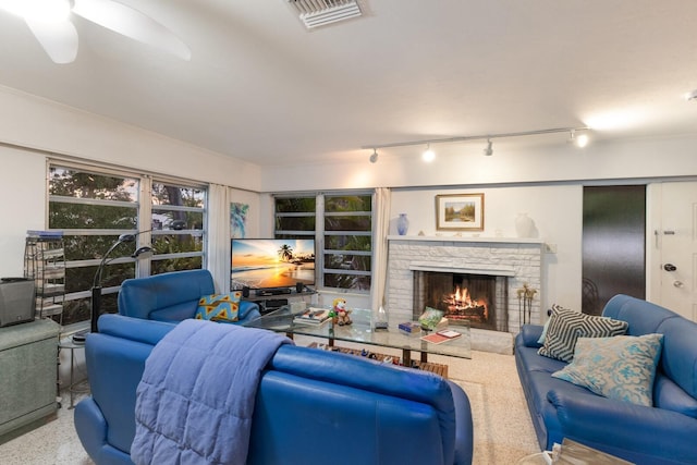 2207 Hickory Ave, Sarasota, FL 34234 - living area with a fireplace, rail lighting, and ceiling fan