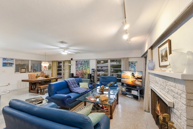 2207 Hickory Ave, Sarasota, FL 34234 - living room featuring speckle patterned floor, a fireplace, a ceiling fan, and track lighting