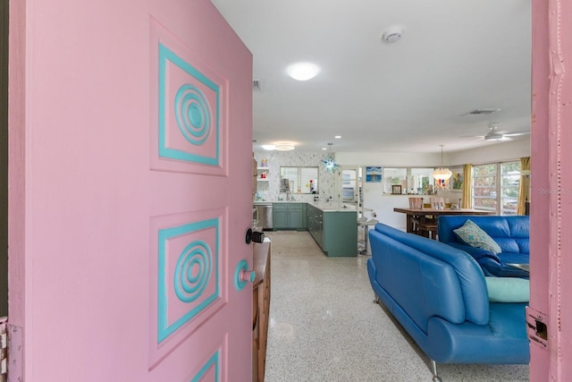 2207 Hickory Ave, Sarasota, FL 34234 - living room with dark speckled floor and ceiling fan