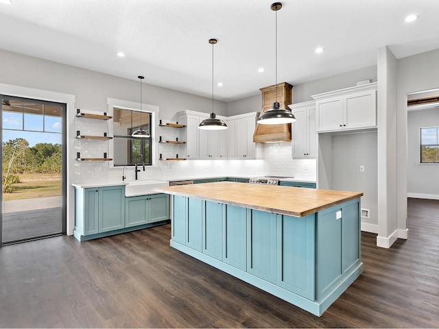 kitchen with open shelves, wooden counters, plenty of natural light, and white cabinets