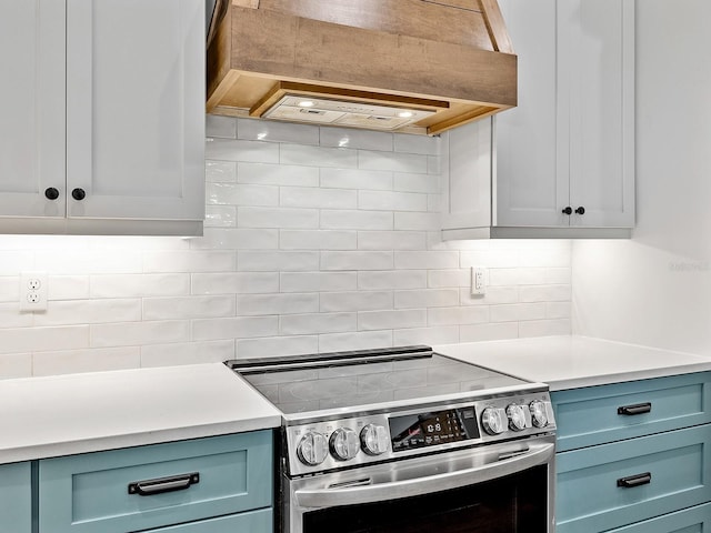 kitchen with light countertops, electric stove, decorative backsplash, and custom range hood
