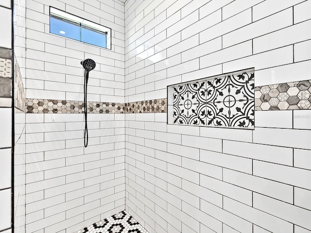full bath with a tile shower