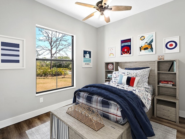 bedroom with ceiling fan, baseboards, and wood finished floors