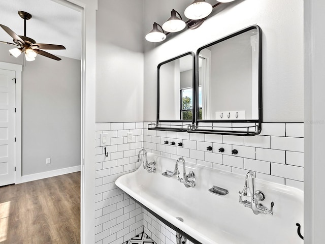 bathroom with ceiling fan, decorative backsplash, and wood finished floors