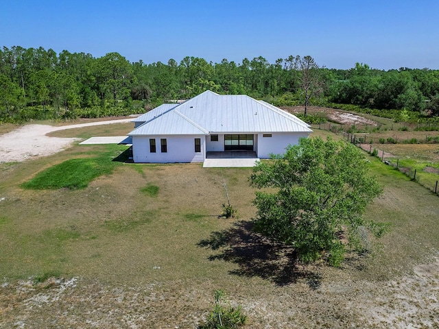 drone / aerial view with a wooded view