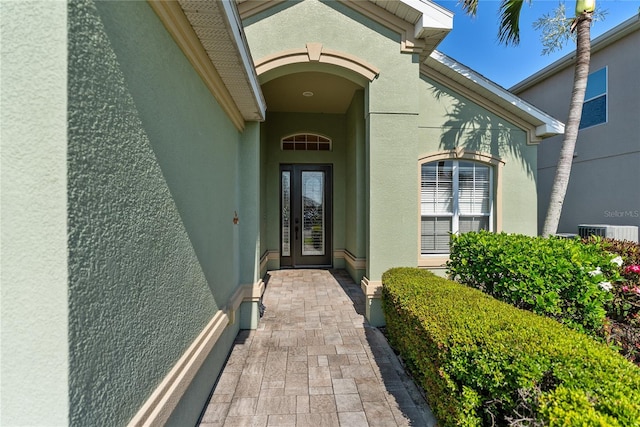 property entrance with stucco siding