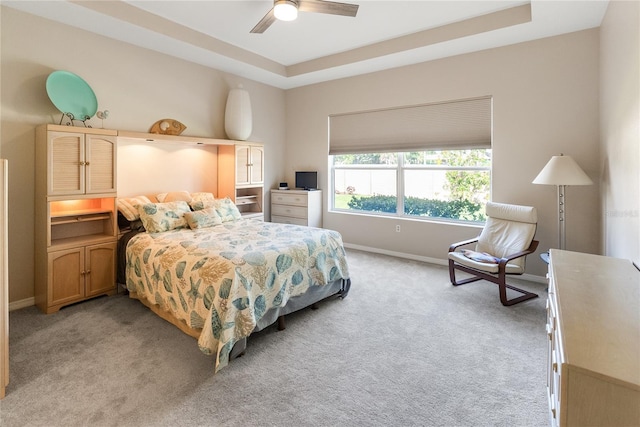 bedroom featuring light carpet, baseboards, and a ceiling fan